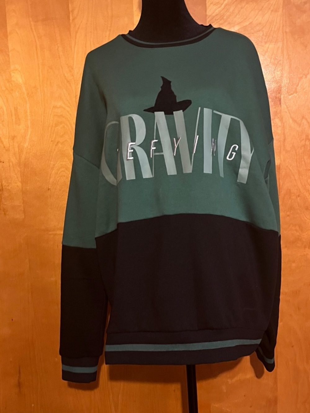 Wicked “DEFYING GRAVITY” Two-Tone Green & Black Crewneck Sweatshirt
